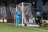 Play is on hold as workers set up a replacement goal during Central Coast Mariners v Perth Glory.