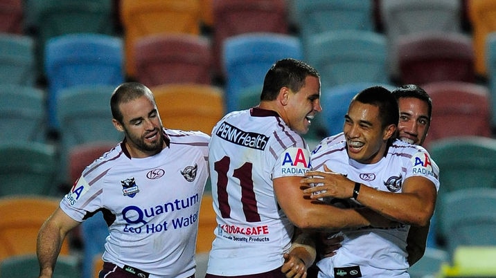 Moving on ... Dean Whare (r) celebrates with Manly team-mates after scoring a try