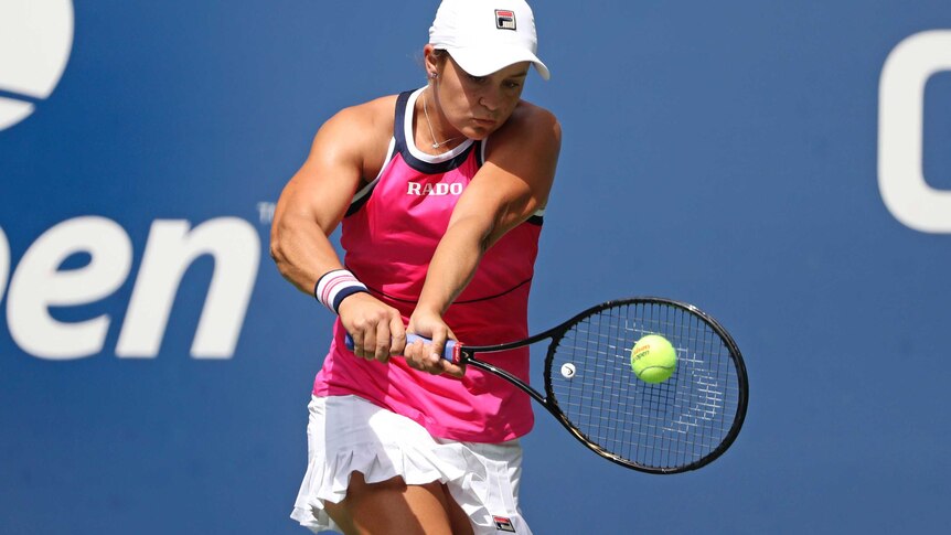 Ash Barty plays a double-handed back hand and watches the ball hit her racquet