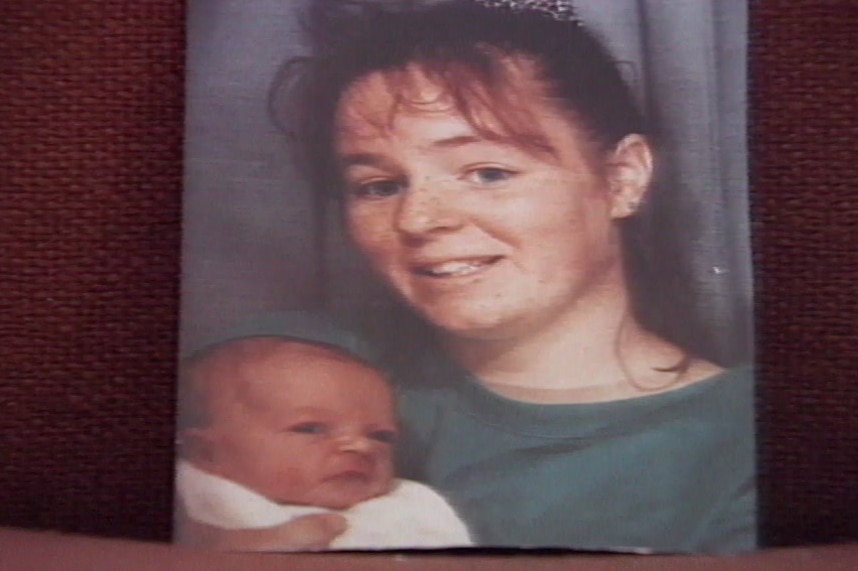 A still from an old TV tape which shows a photo print of Victoria holding her baby.