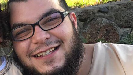 Khaled Temssah, wearing glasses, smiling outdoors.