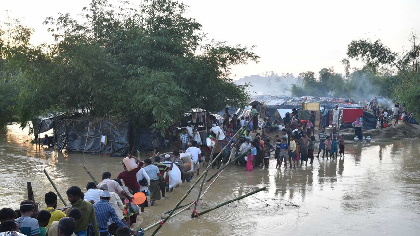 Rohingya refugees cross the river to a Bangladesh border camp.