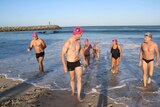 The swimming365 group emerge from the ocean.