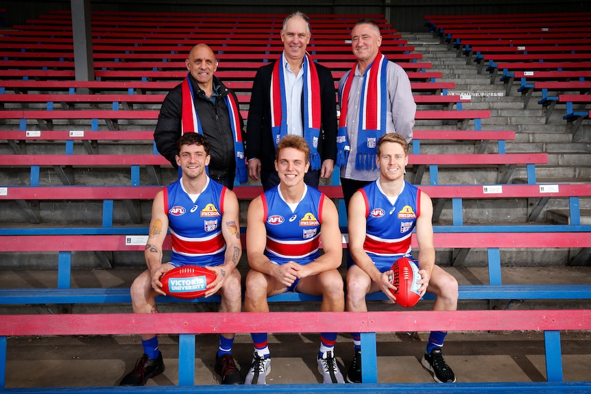 Footscray/Bulldogs' Tony Liberatore stands behind son Tom, Steve Wallis behind son Mitch, and Mark Hunter behind son Lachie.