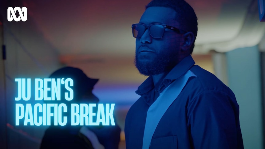 A man wearing sunglasses is lit by blue lighting. Text reads: Ju Ben's Pacific Break.