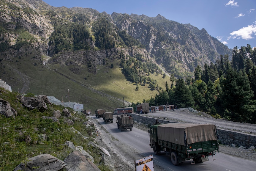 An Indian army convoy moves through a mountainous region