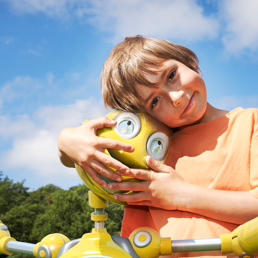 young boy hugging his robot companion