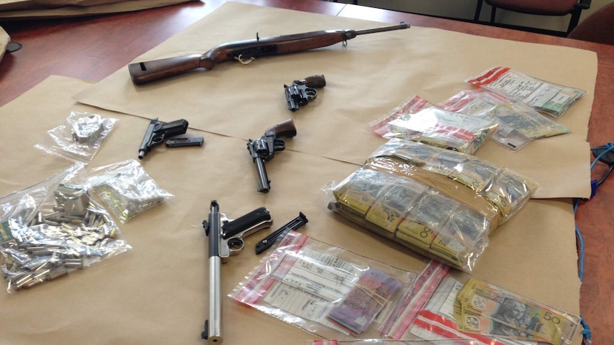 Police display guns cash seized at Launceston airport.