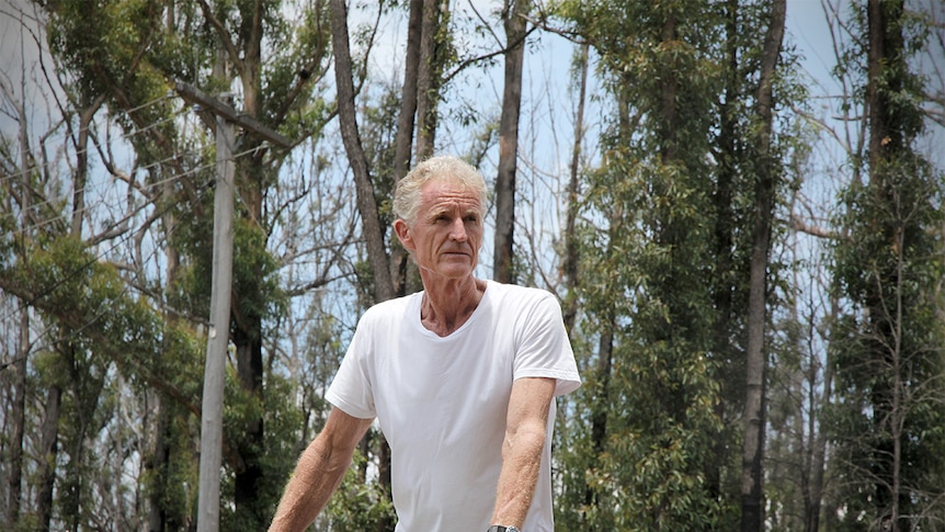 Greg Webb at the site where his home once stood gazing over a balcony.