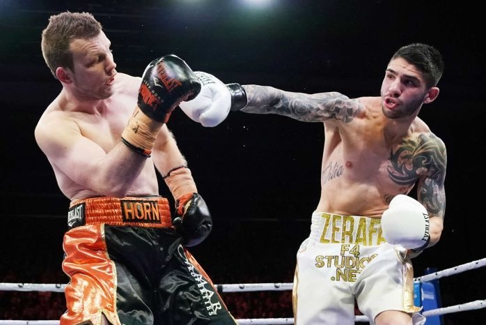 Two men boxing in a boxing ring.