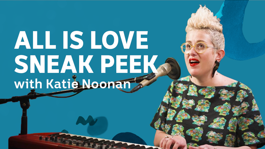 Singer song writer Katie Noonan sits singing at a keyboard with the test "All is Love Sneak Peek with Katie Noonan" next to her