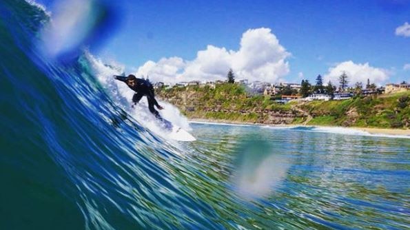 A surfer catching a wave