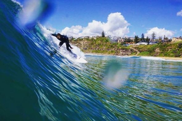 A surfer catching a wave