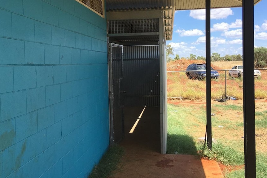 A concrete entrance to the shed-like house.