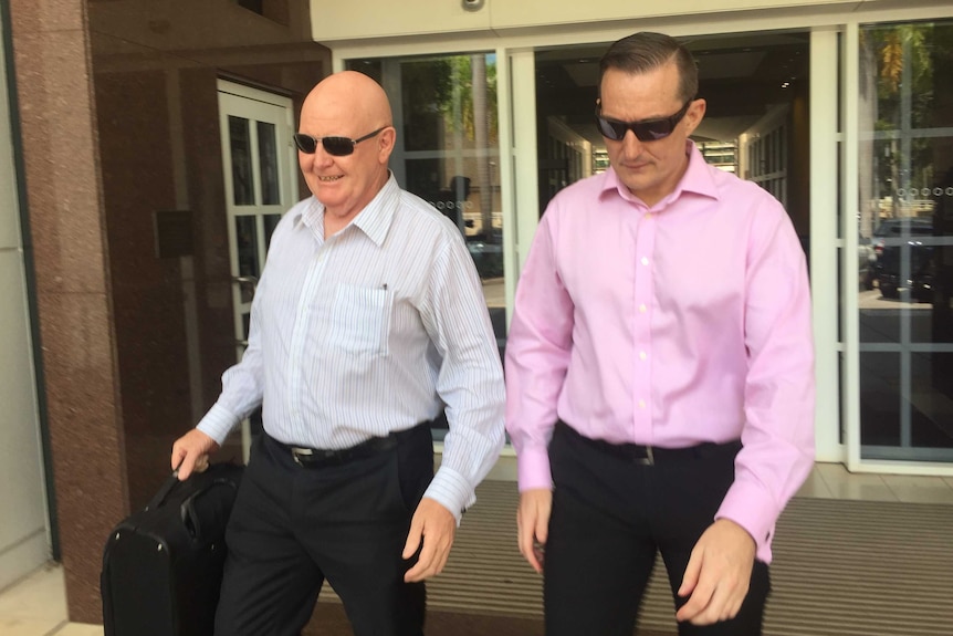 Former NT government staffer Paul Mossman (right) and his lawyer Tom Berkley leave court.