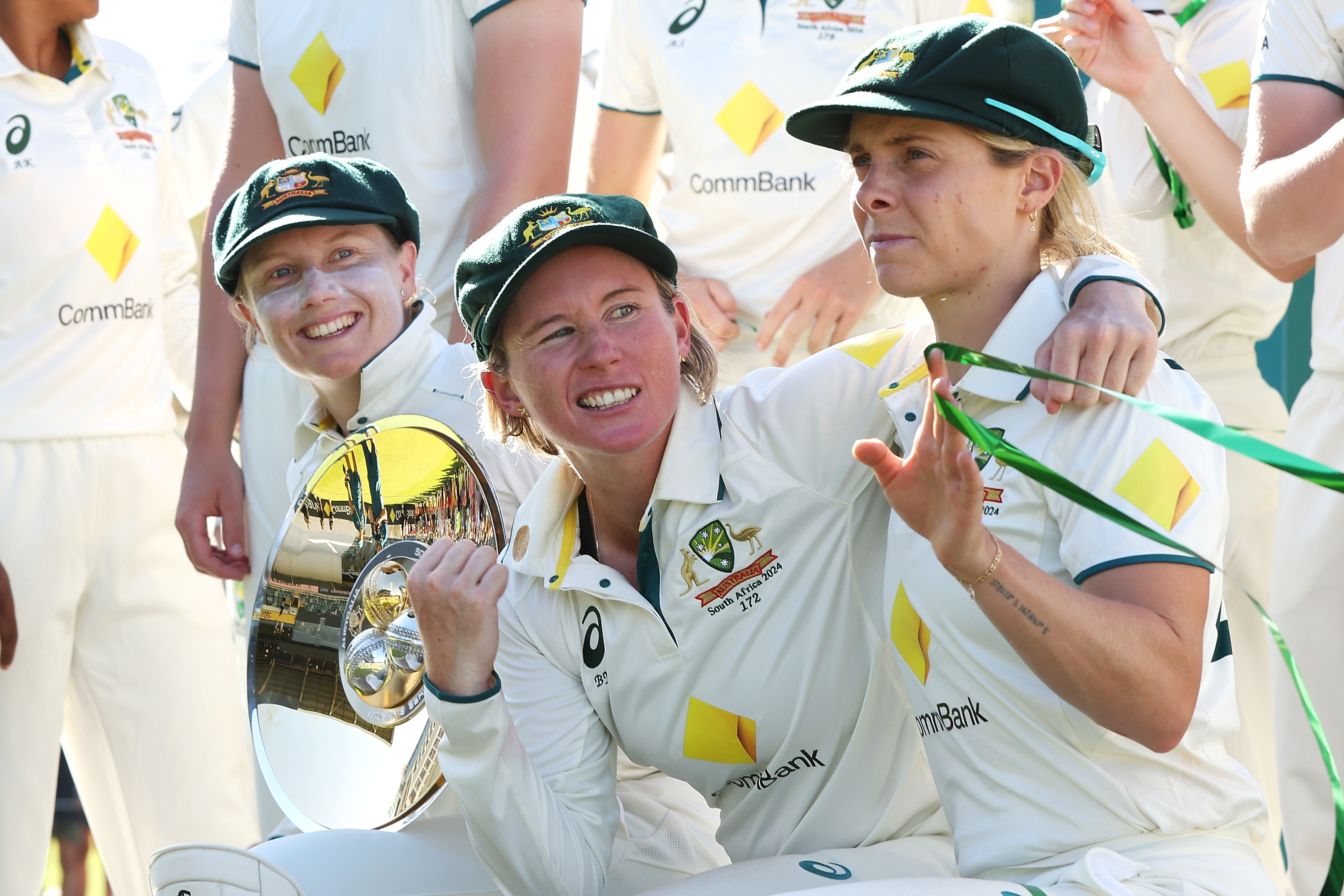 Alyssa Healy, Beth Mooney and Sophie Molineux celebrate after beating South Africa in the Test at the WACA.