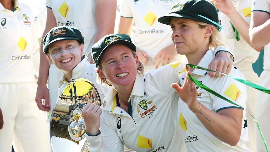 Alyssa Healy, Beth Mooney and Sophie Molineux celebrate after beating South Africa in the Test at the WACA.