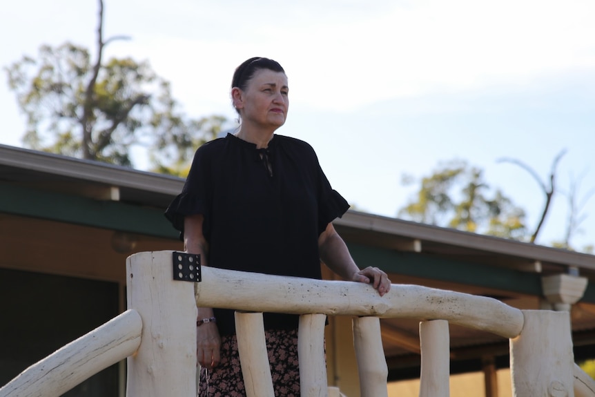 Myree gazes out from her balcony.