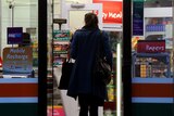 A woman walks into a 7/11 (Seven Eleven) convenient store