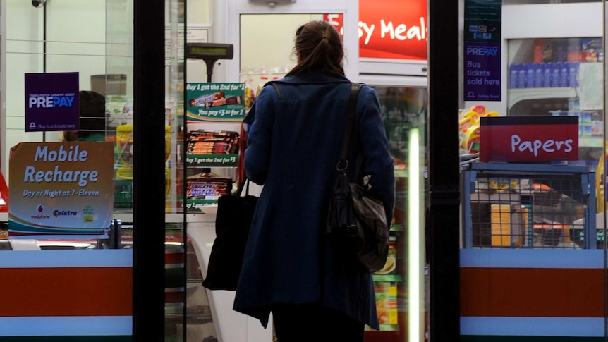 A woman walks into a 7/11 (Seven Eleven) convenient store