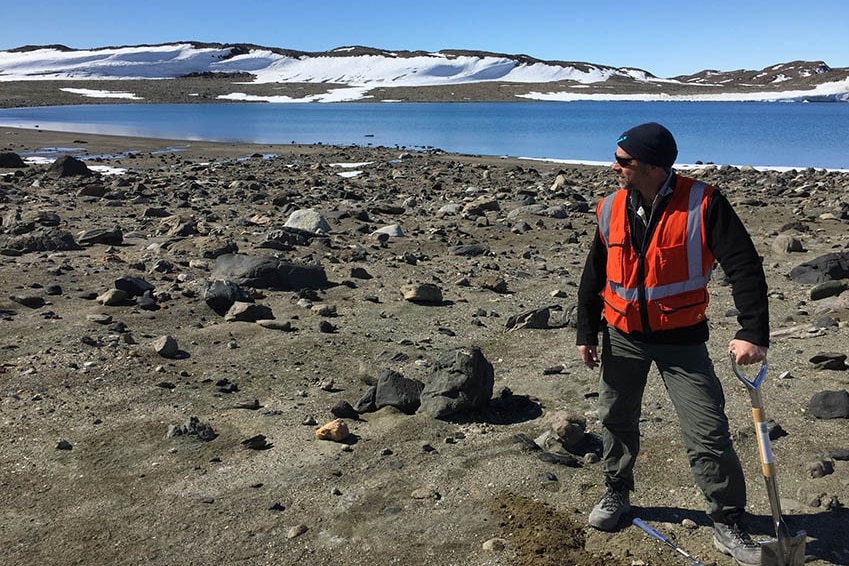 Geologist Alistair Reed with a shovel in Antarctica