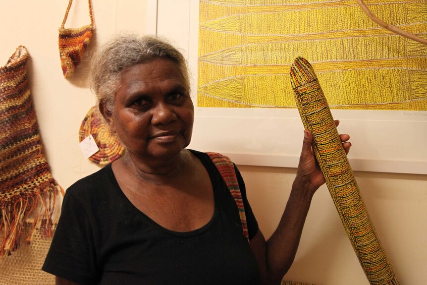 Artist Regina Wilson with her carvings, painting, and weavings.