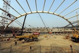 Indian labourers work on the Commonwealth Games Cycling Velodrome in New Delhi.