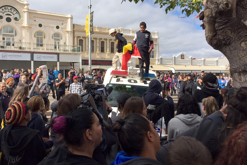 Two children on the roof of a police car in Kalgoorlie.