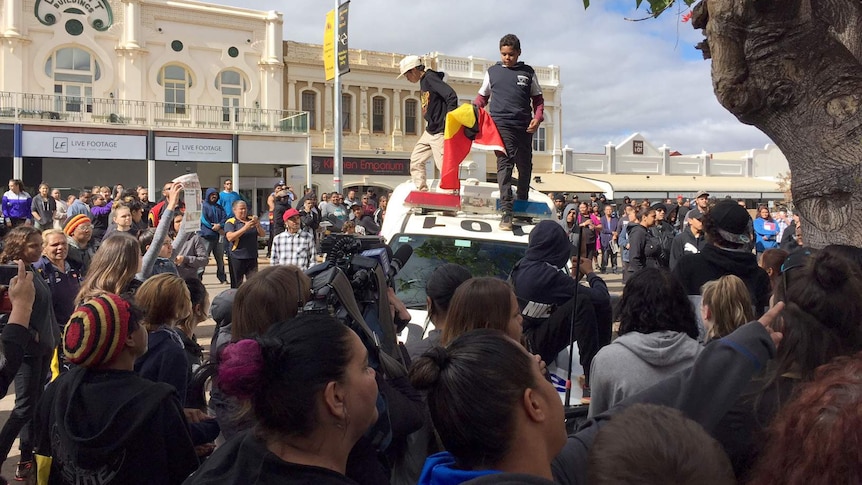 Two children on the roof of a police car in Kalgoorlie.
