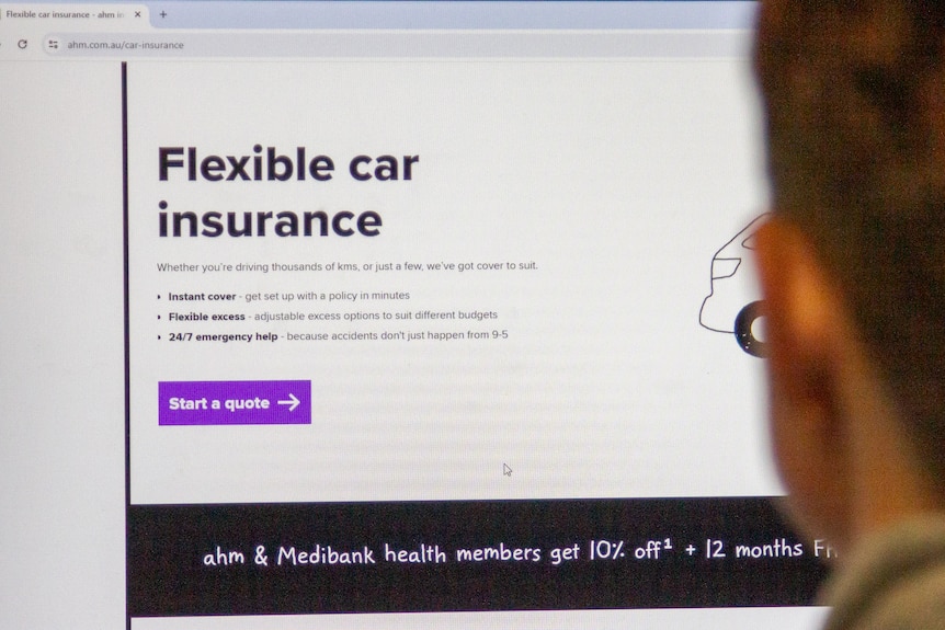 A photo of a person looking at a computer screen showing the AHM car insurance quote landing page