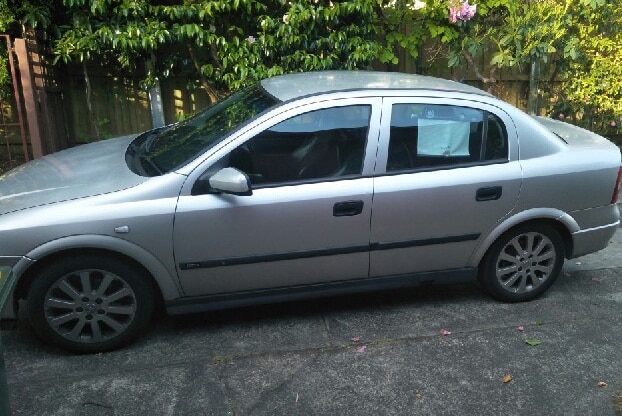 Silver car in a driveway.