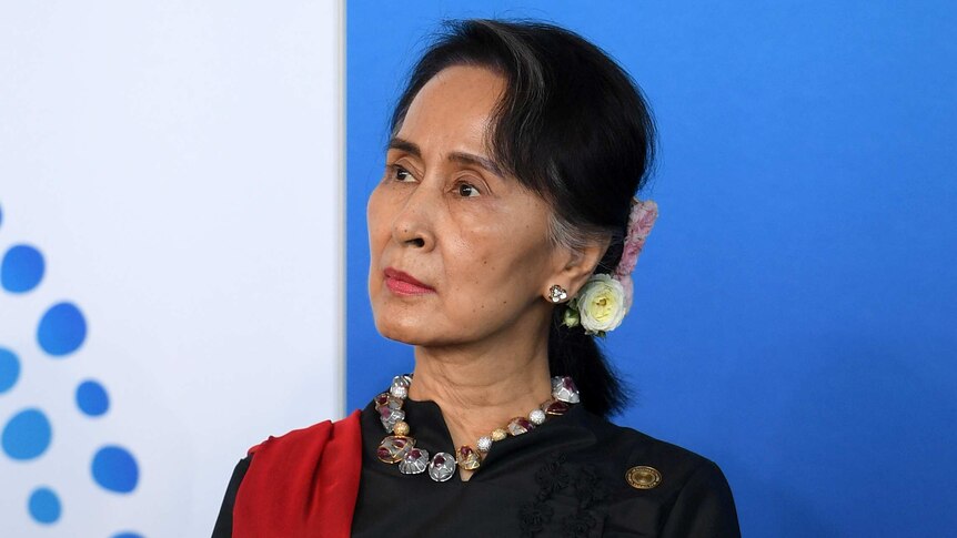 Aung San Suu Kyi looks to her right.