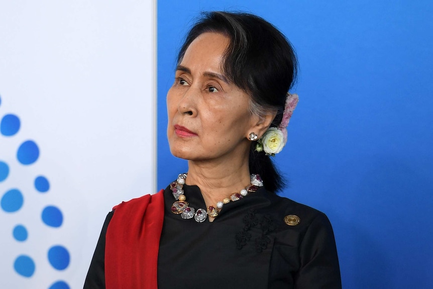 Aung San Suu Kyi looks to her right.