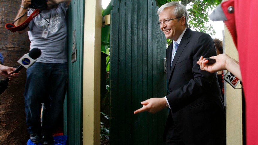Kevin Rudd leaves his home for a news conference