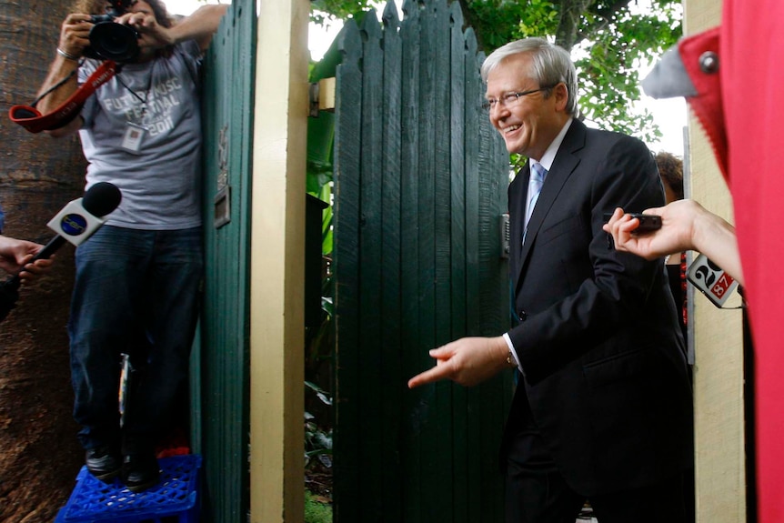 Kevin Rudd leaves his home for a news conference