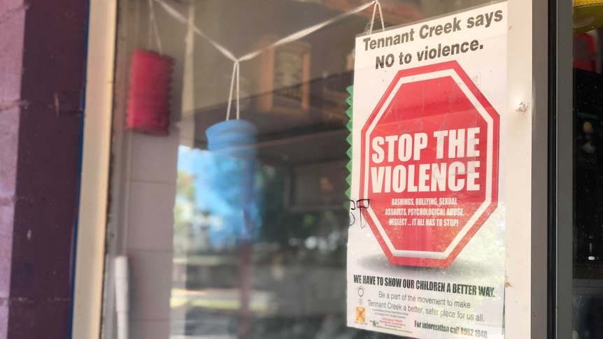 A 'Stop The Violence' sign on a shop window