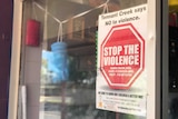 A 'Stop The Violence' sign on a shop window