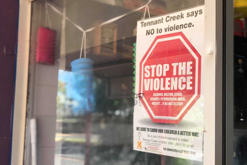 A 'Stop The Violence' sign on a shop window