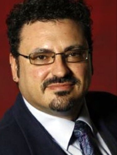 Jesus Hidalgo wearing glasses, a suit and tie