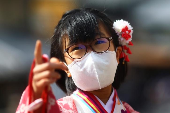 A girl in a kimono and face mask