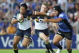 On the move ... Christian Lealiifano breaks a tackle by Josh Tatupu