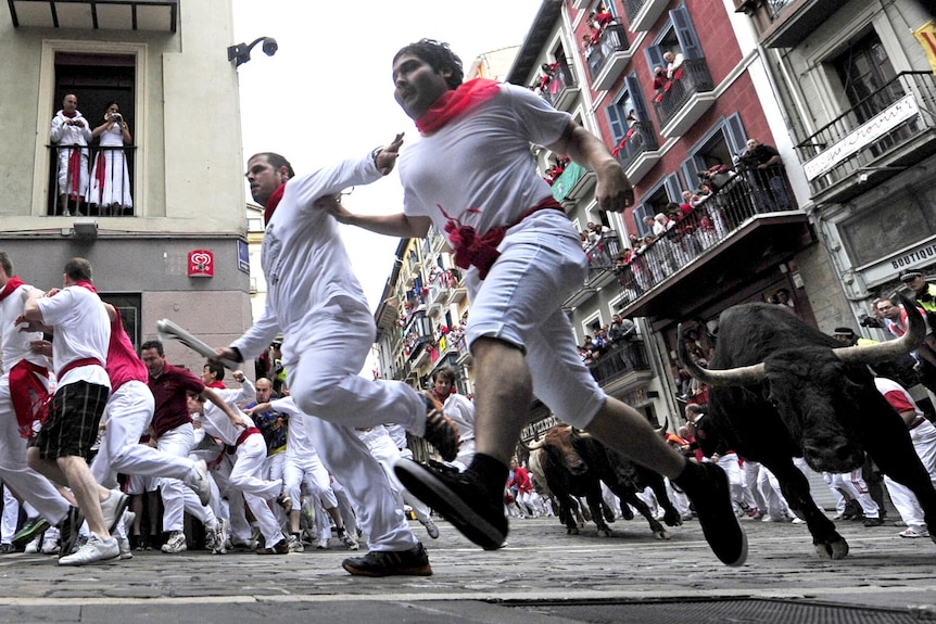 Participants run with the fighting bulls in Pamplona