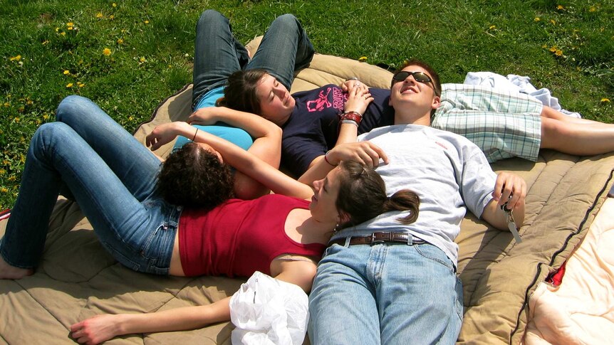 Friends lying on one another sleeping