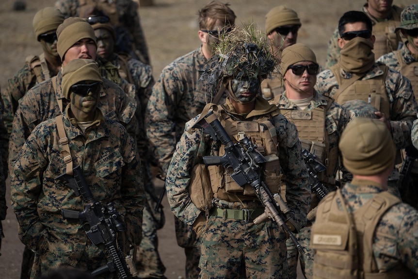 A group of US marines dressed in camouflage and face paint
