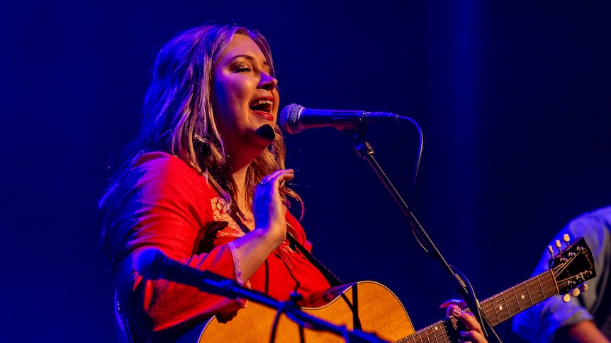 Country music singer-songwriter Melody Moko singing live on stage