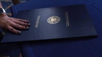 A dark blue folder with the US Congress crest on it.