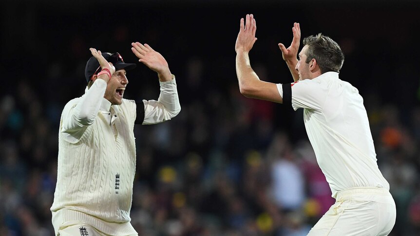 Craig Overton and Joe Root celebrate after dismissing Steve Smith for 40 runs.