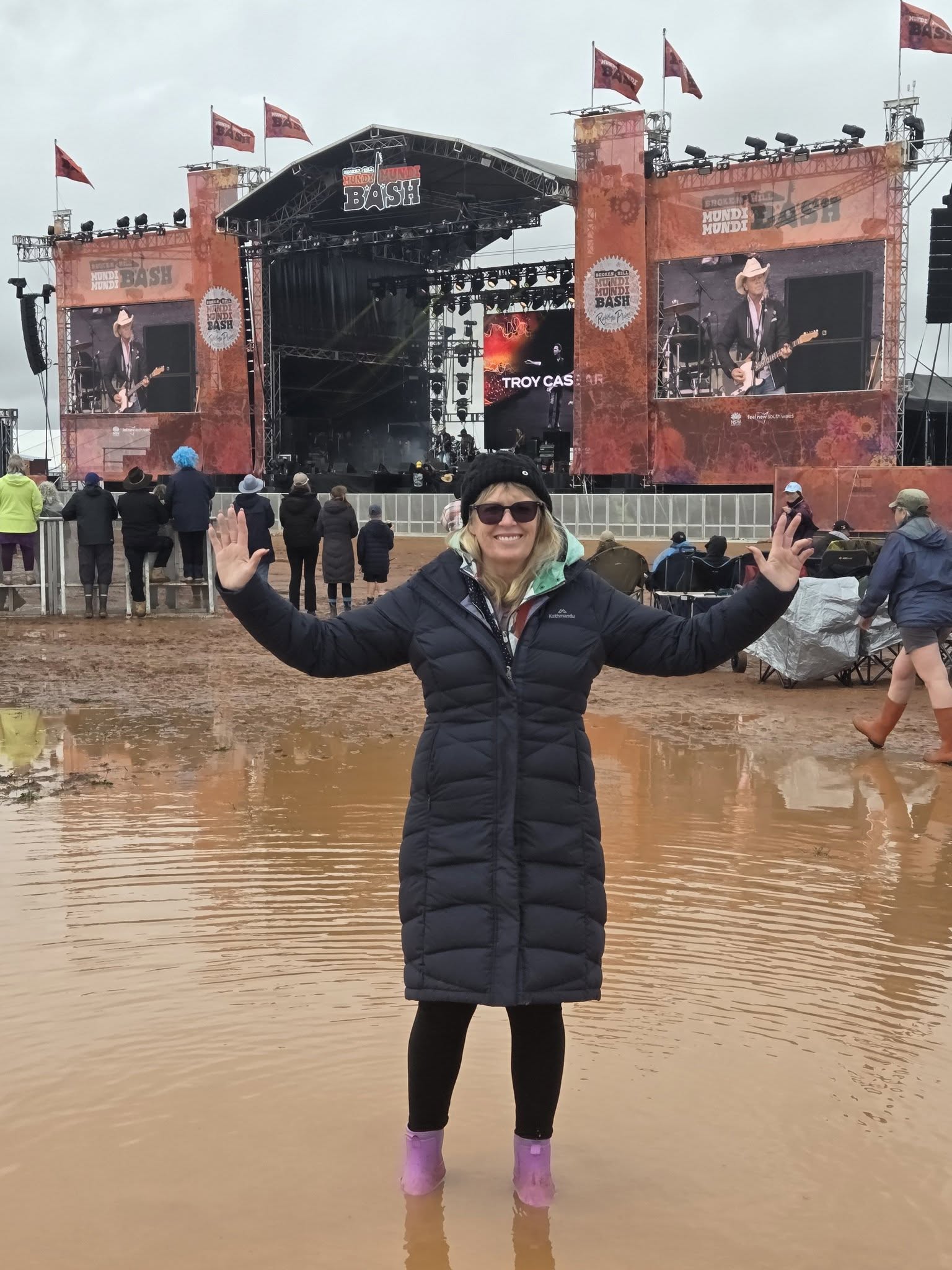 Sharyn Cunningham stands in water at the site of the Mundi Mundi bash music festival.