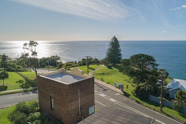 The view looking east from a drone over the Clifton School of Arts with the ocean in the background.