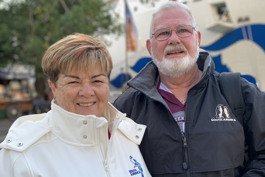 Two people smiling at the camera 